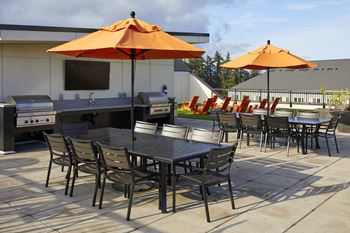 a patio with tables and chairs and umbrellas